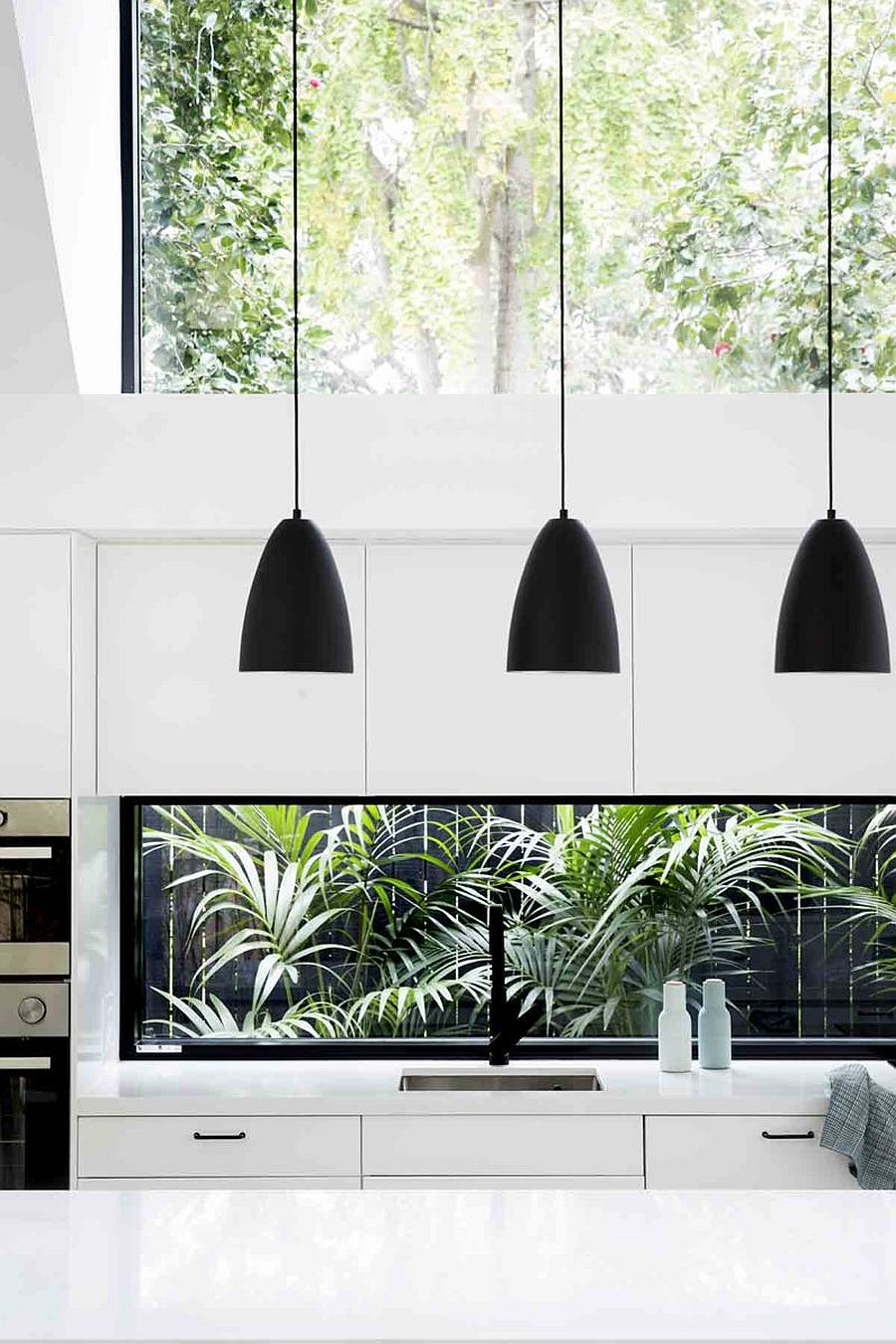 Dark-pendant-lights-usher-in-visual-contrast-to-a-setting-that-is-draped-entirely-in-white-61252