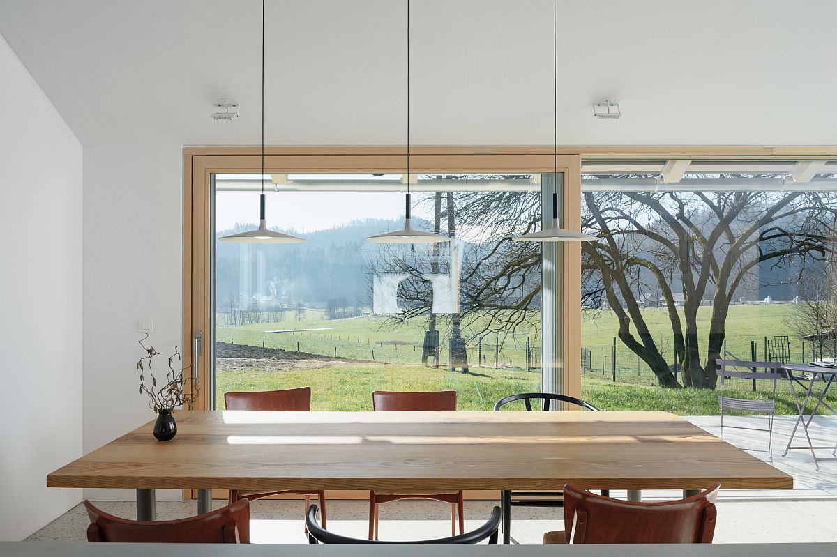 Dining room with wooden table offers fabulous views of the scenery outside