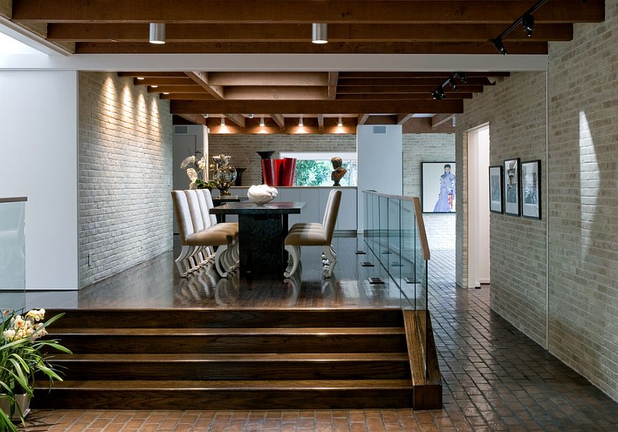 Dining space on a platform is surrounded by whitewashed brick walls all around