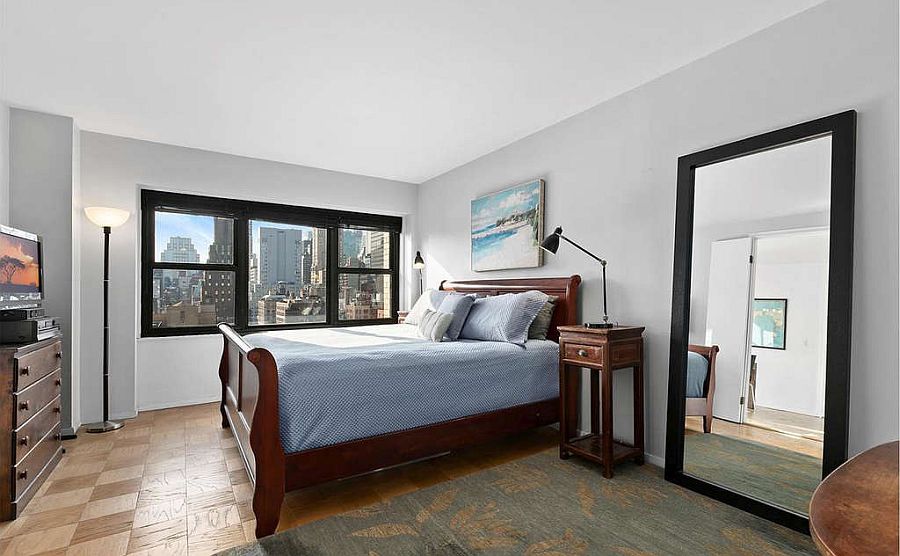 Empire State Building views make the biggest impact inside the small monochromatic bedroom