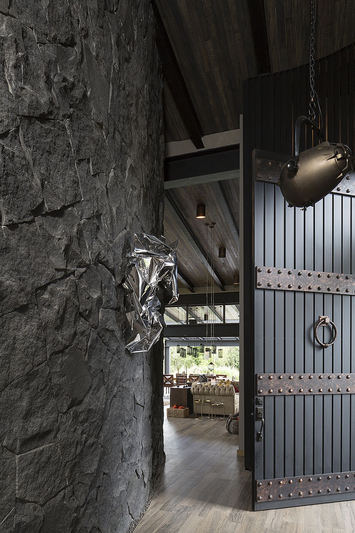 Entrance of the house with traditional Mexican design touches and dark stone walls