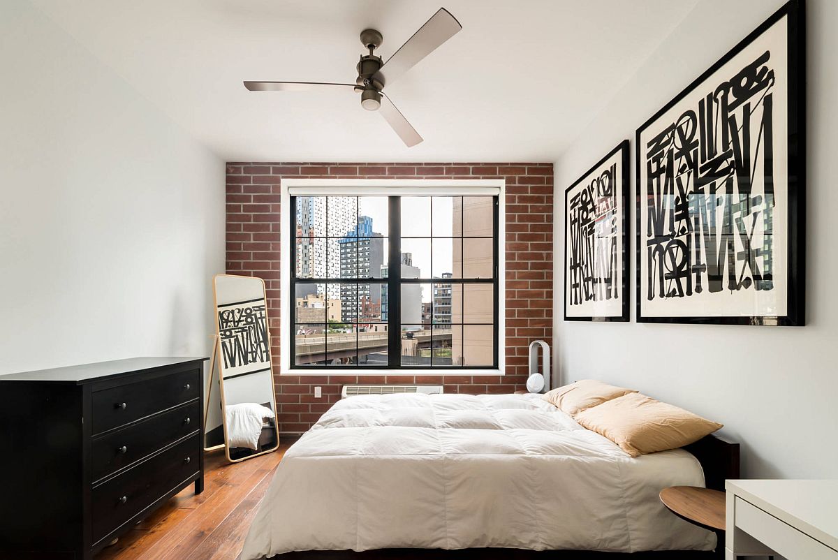 Glam NYC bedroom in white with chic frame art workand faux brick wall