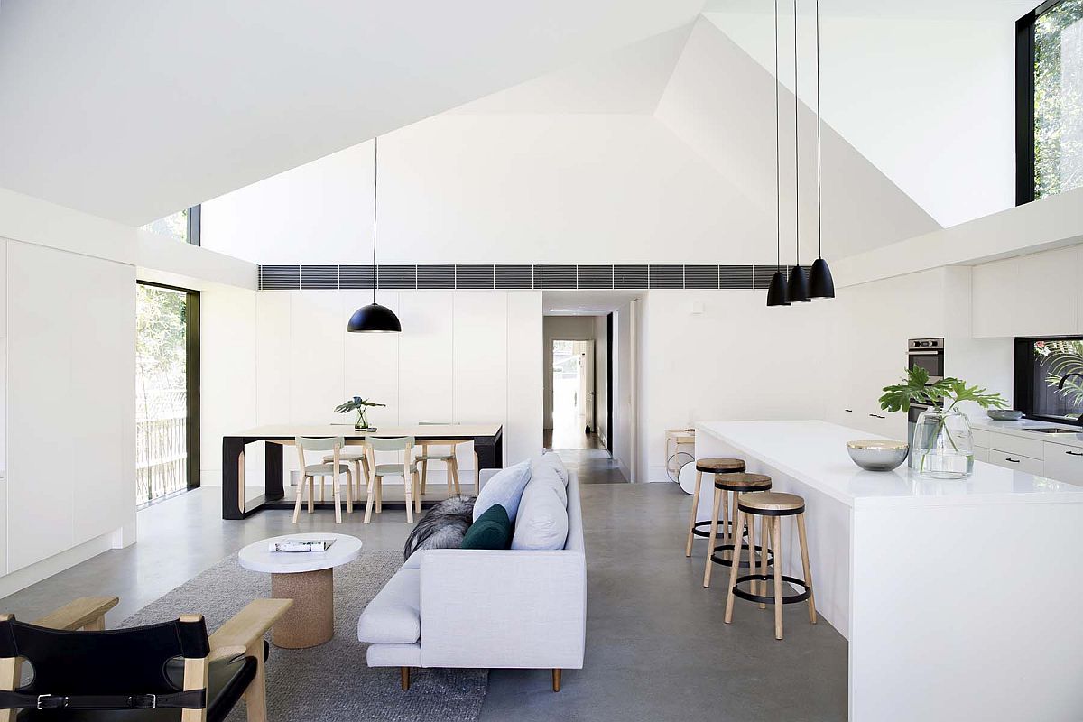 Gorgeous living area of the home with white, monochromatic interior, concrete floor and black accents