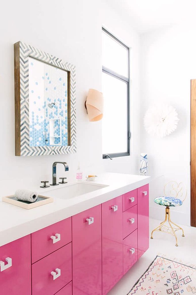 Gorgeous pink vanity with white countertop and a bright, lacquered finish