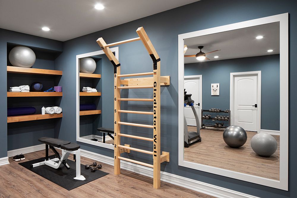 Gorgeous small home gym in gray with a mirror and shelf space