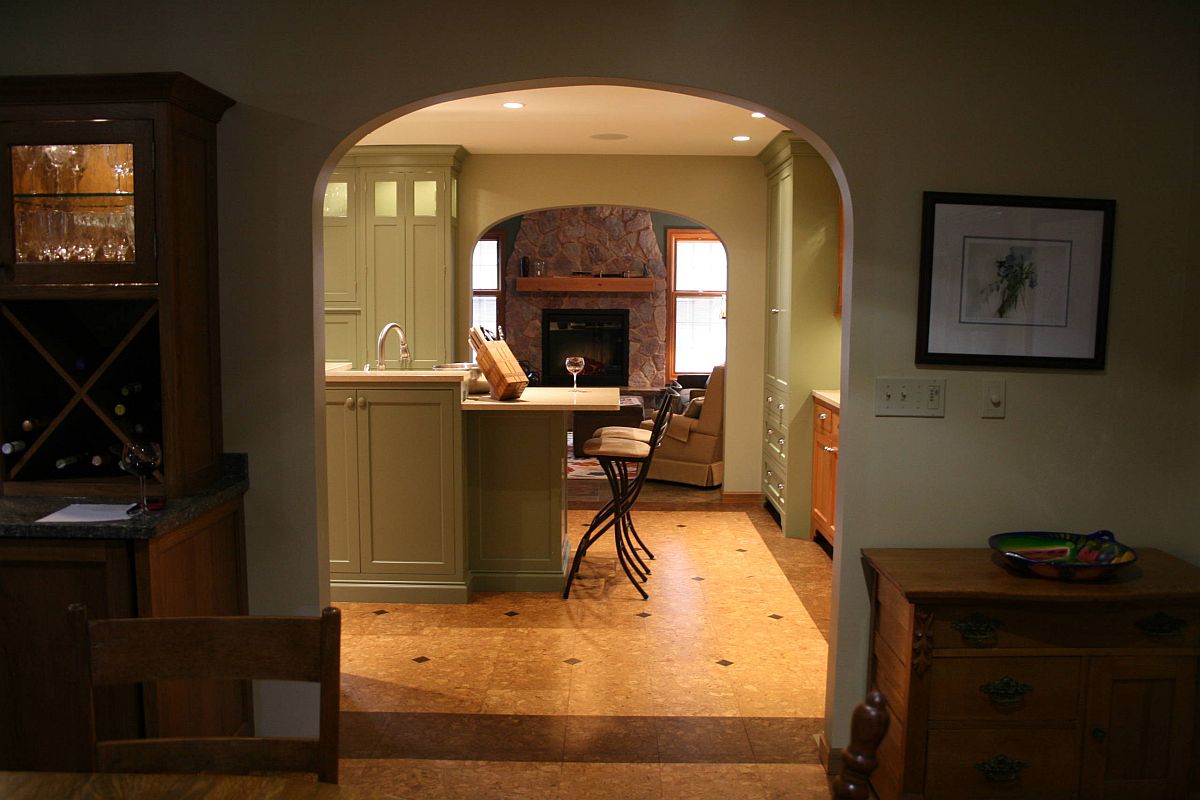 Green walls and cabinets add color to the kitchen with cork floor