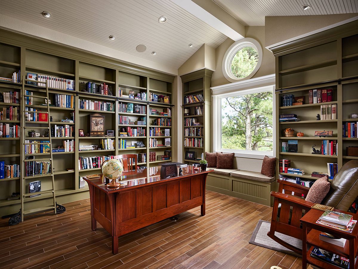 Home office with extensive olive green shelves and a ceiling in white looks exquisite