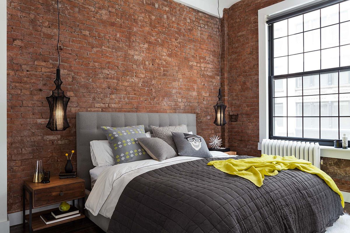 Industrial-modern-bedroom-with-exposed-brick-walls-and-a-large-window-inside-New-York-home-90540