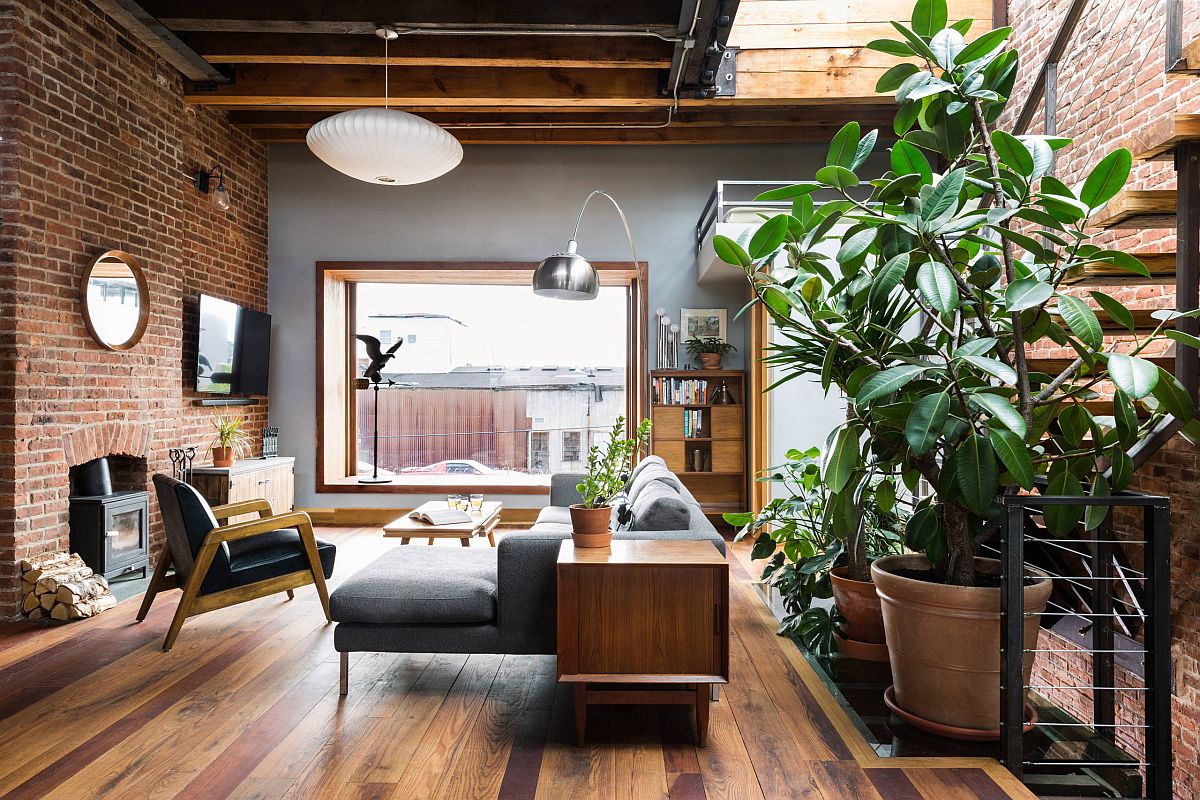 Industrial style living room where brick walls and wooden floor add ample contrast