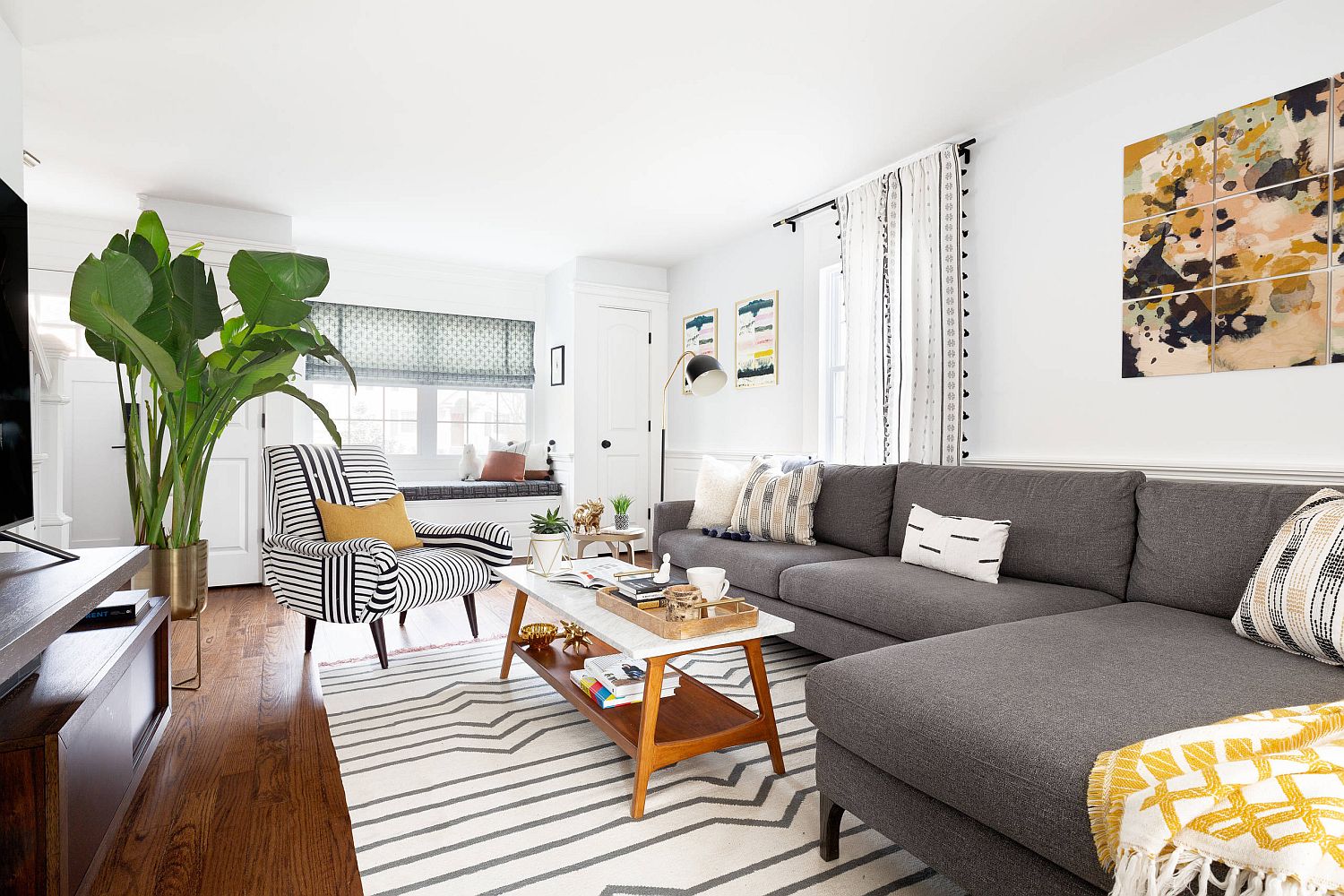 Interesting use of multiple stripes on the accent chair along with the rug give this contemporary living room a snazzy appeal