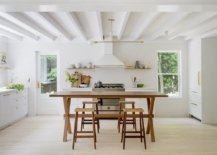 Kitchen-of-the-Hamptons-home-in-white-with-wooden-table-and-chairs-53242-217x155