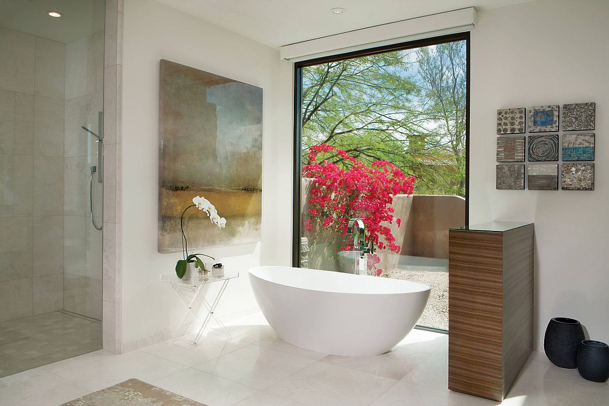 Large wall art piece next to the freestanding bathtub is a trend you should embrace this season