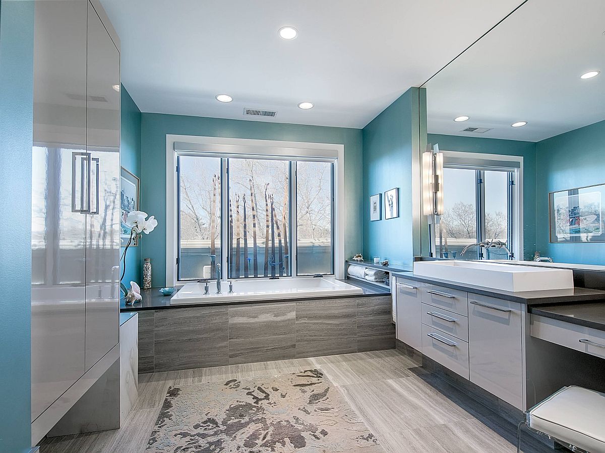 Light-filled and spacious modern bathroom in gray and blue