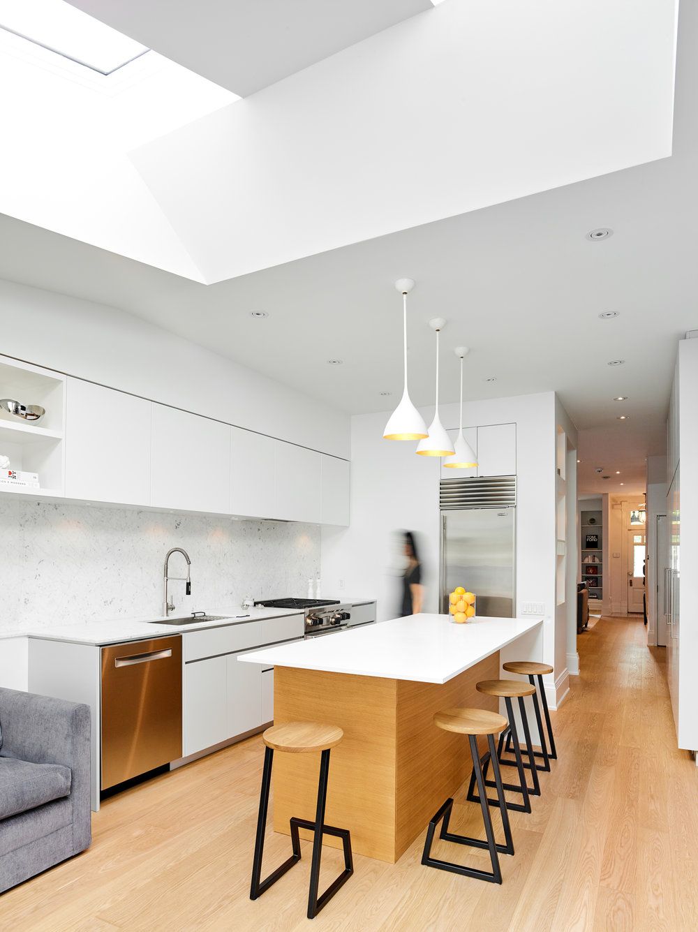 Light-filled and white interior of the Macpherson Renovation in Toronto