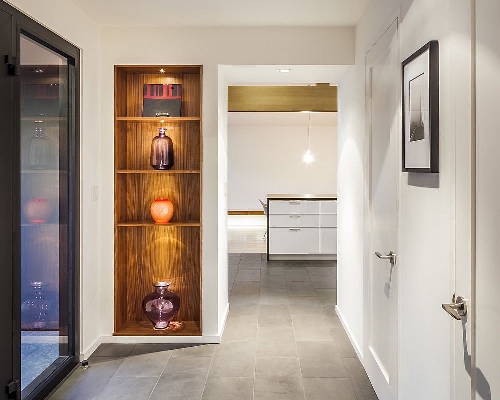 Lighting-for-the-sleek-wooden-corner-shelf-steals-the-spotlight-in-this-hallway-95380