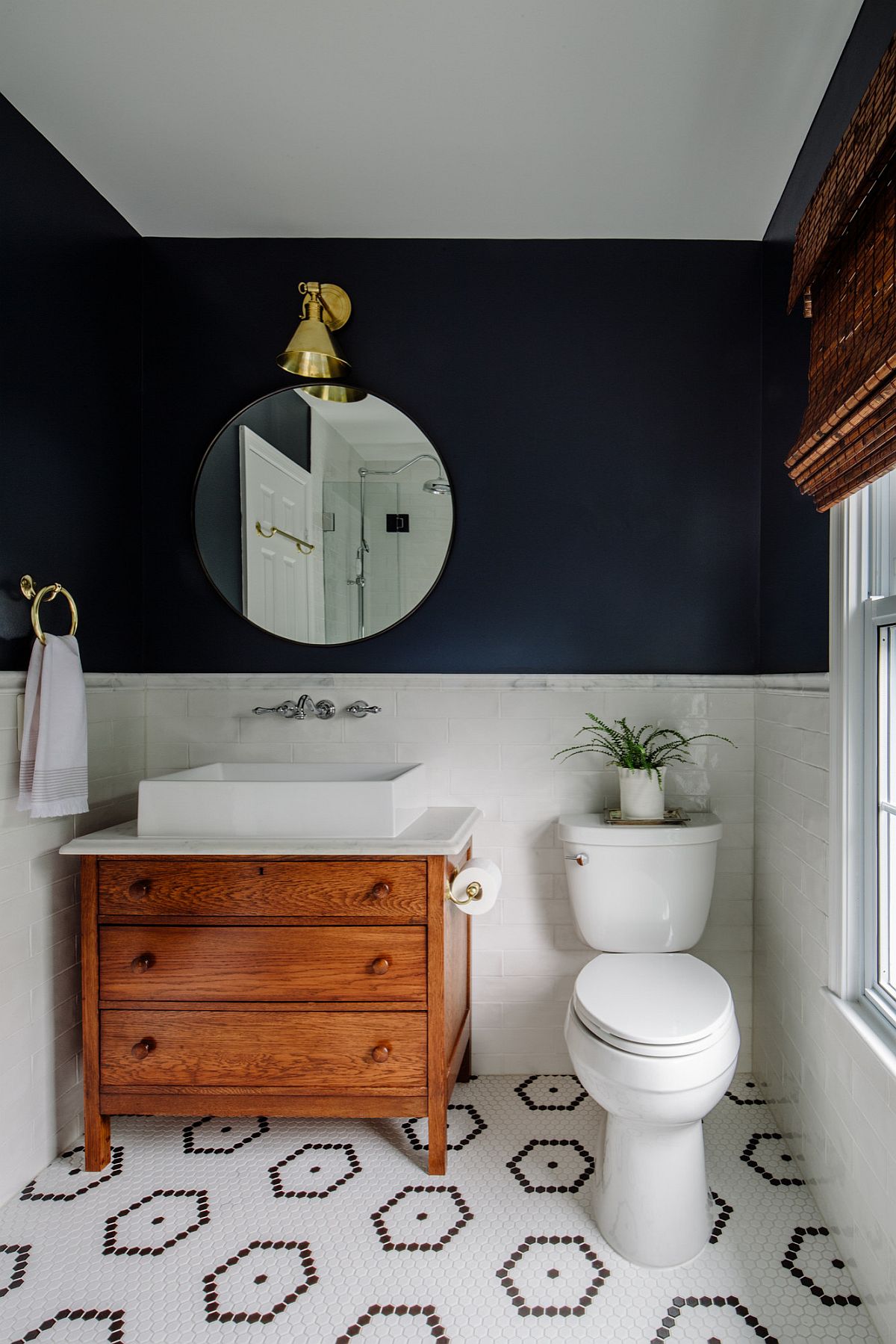 Love the visual balance created by deep Navy Blue and white in his small modern bathroom