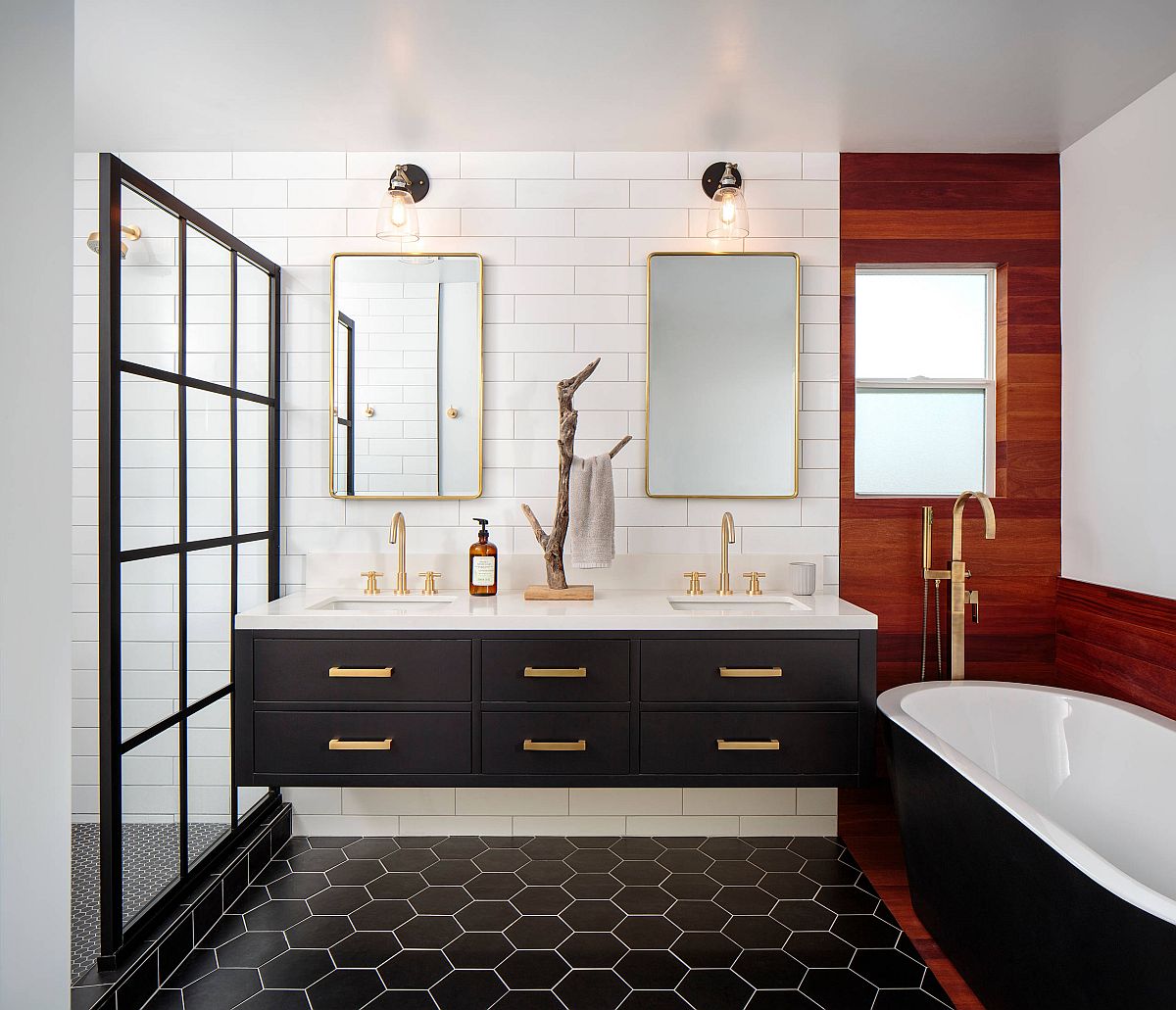 Master bathroom in black and white with brass handles and frames along with wooden accent section