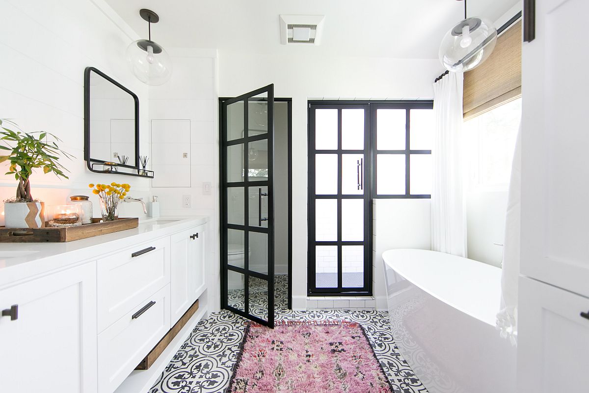 Modern beach style bathroom in white with dark framed doors in glass and an understated pink rug