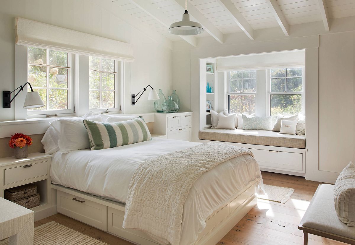 Monochromatic bedroom in white with modern farmhouse style and a cozy built-in window seat