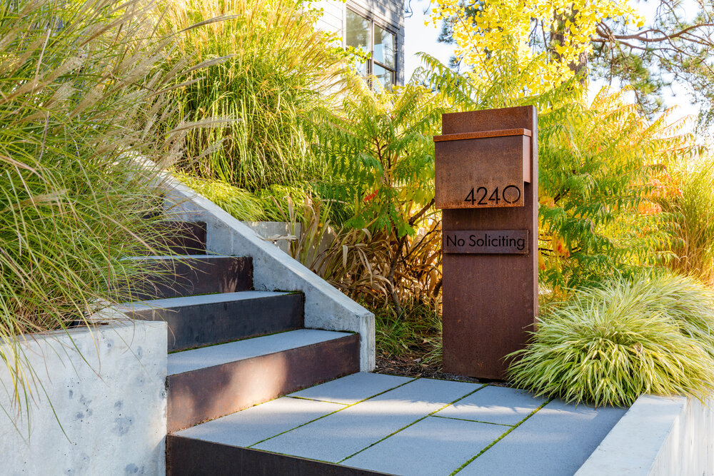 New post box of the house with custom metal design also displays the number