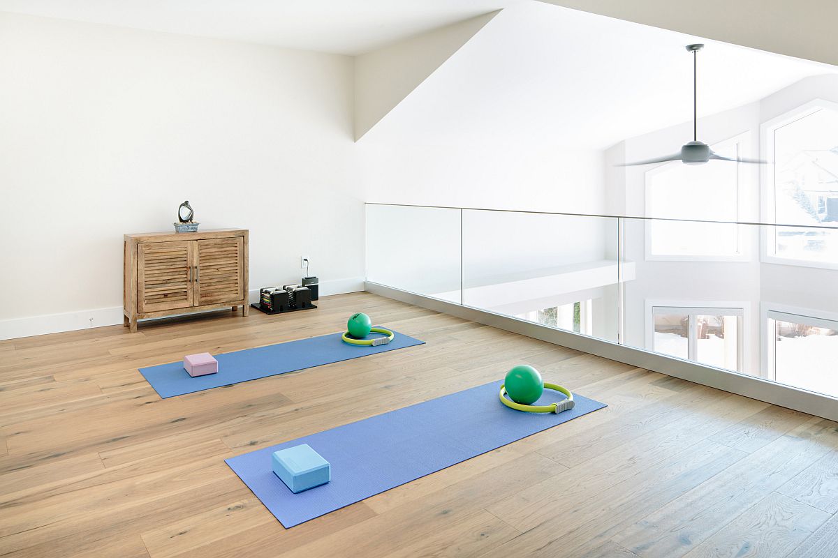 Open staircase landing zone turned into a cheerful and airy home workout zone