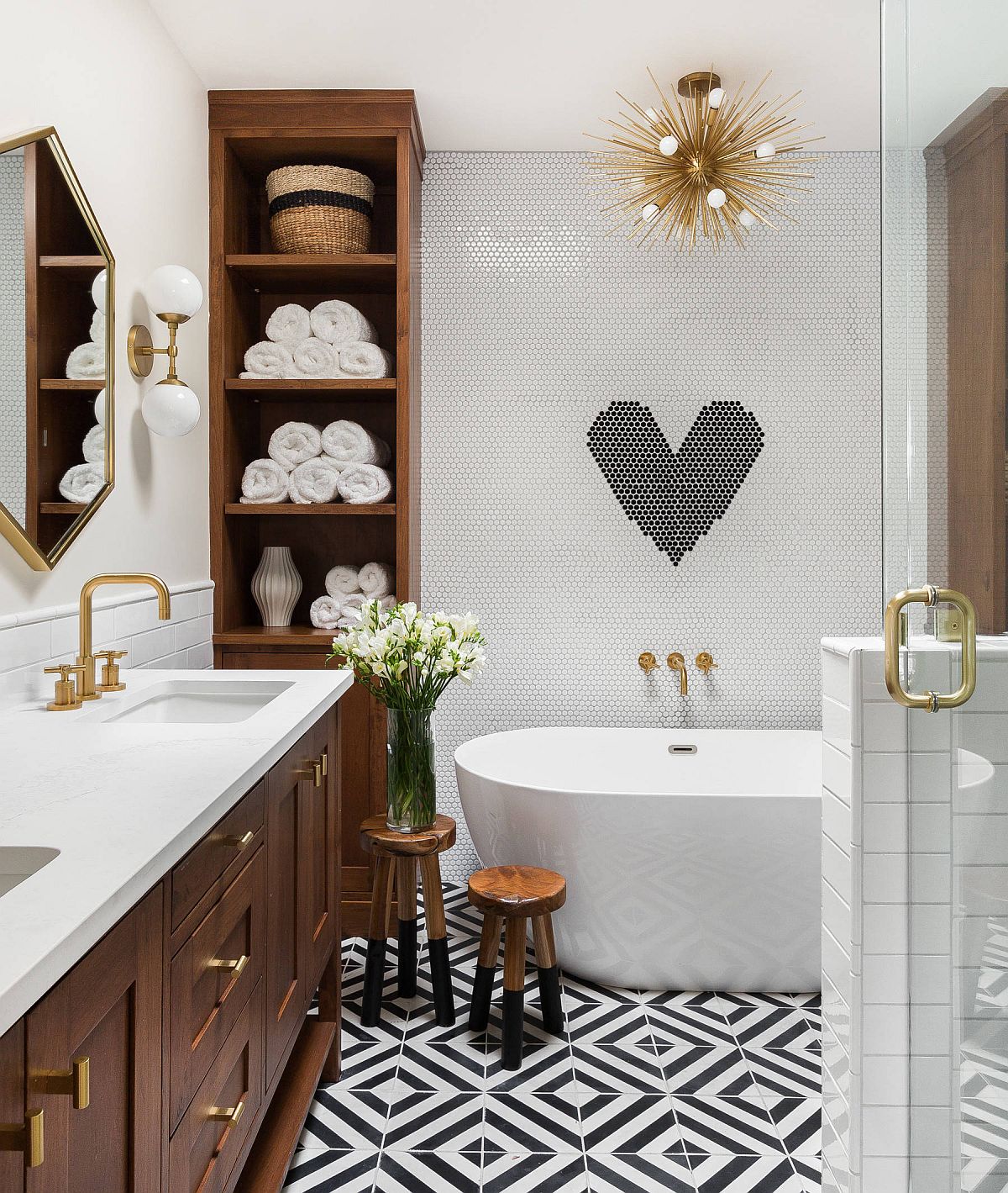 Penny tiles and floor tiles bring pattern to the bathroom in white and black along with wooden vanity