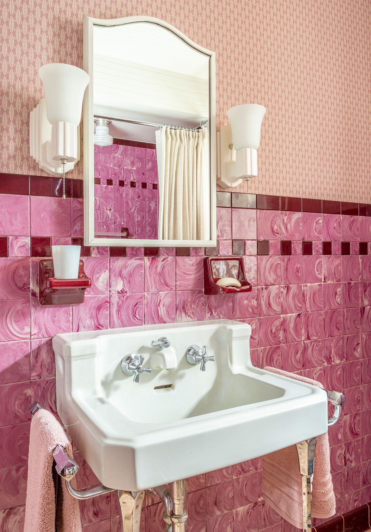 Pink tiles on the wall along with wall-mounted sink for the traditional bathroom remodel