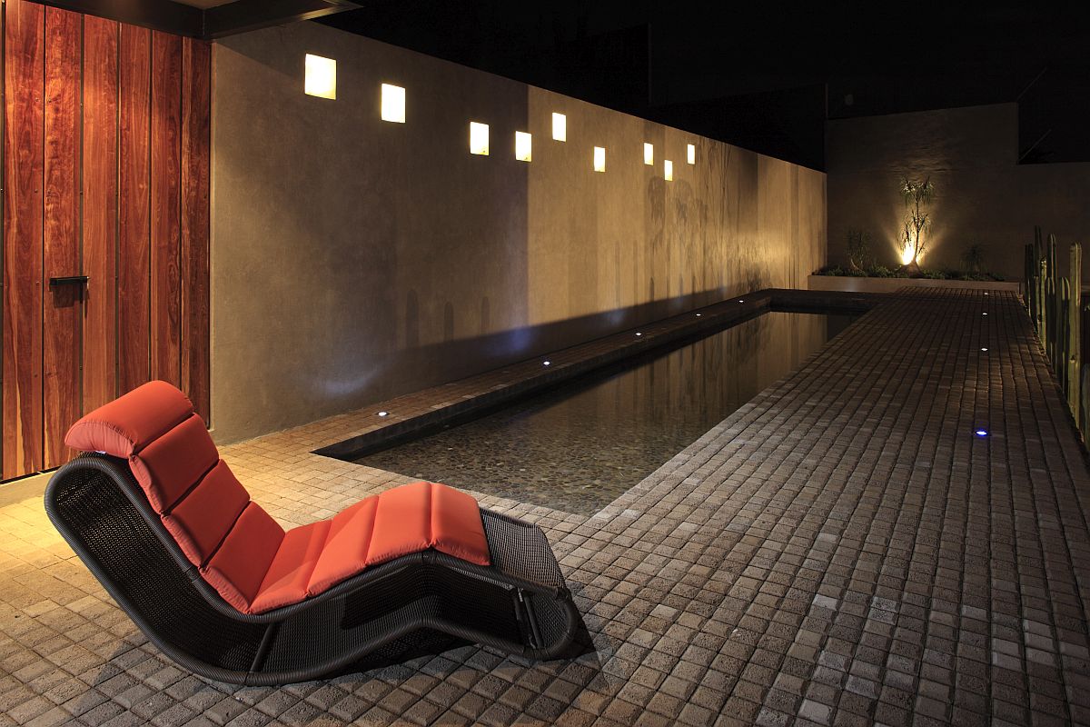 Relaxing poolside seats allow the homeowners to take in the sights and sounds outside