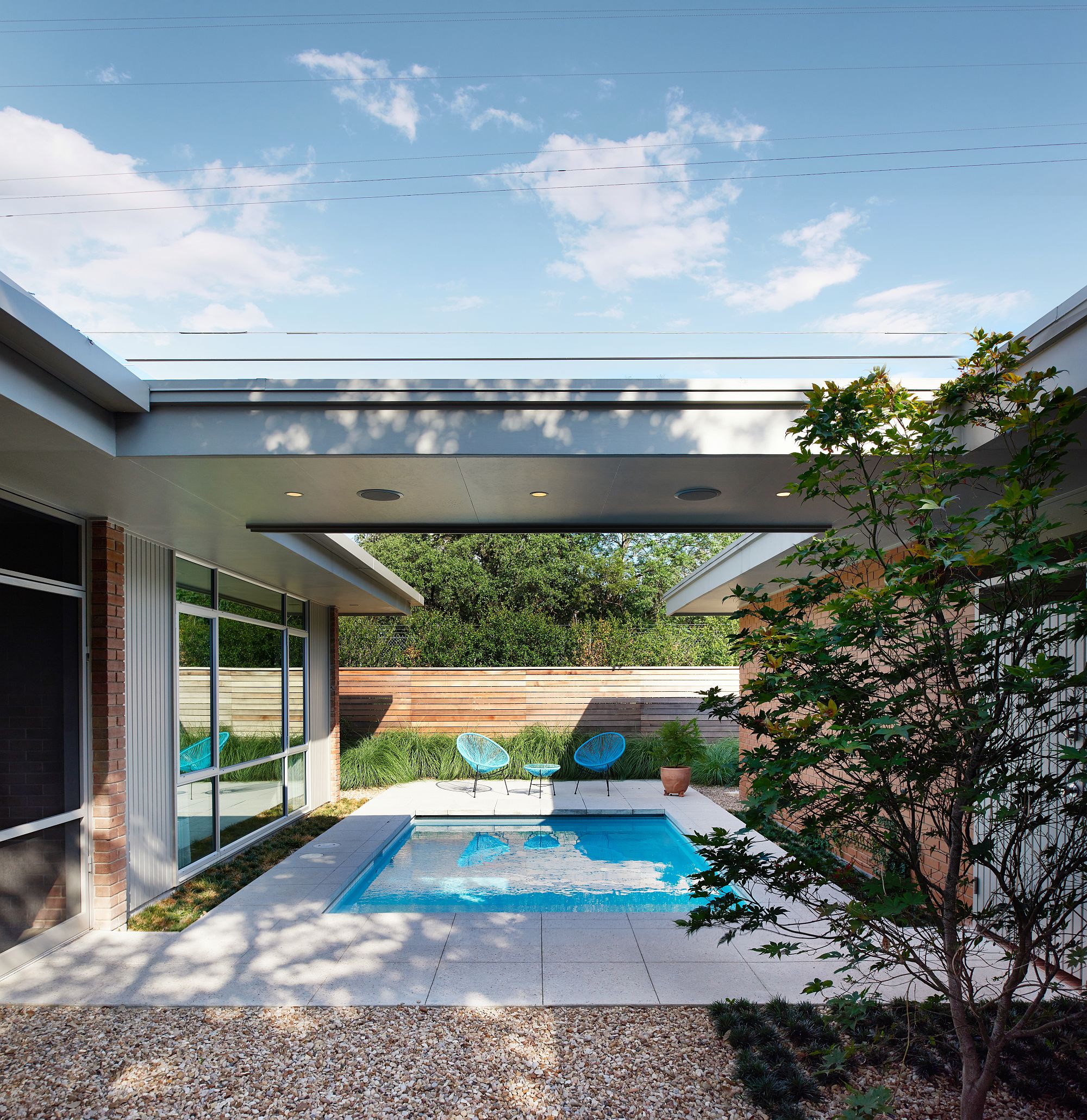 Sheltered outdoor spaces and pool area at the revamped home in Austin