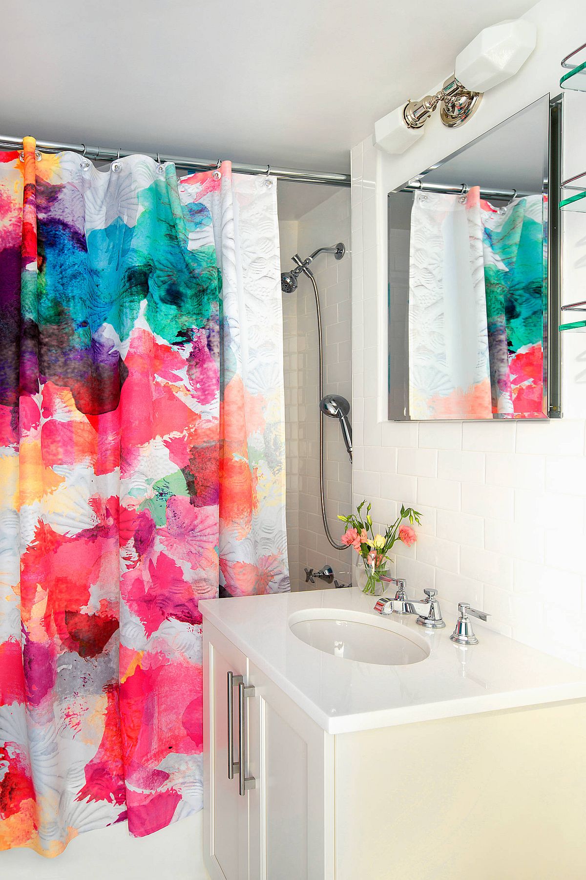 Shower curtains bring splashes of pink and purple into this modern, neutral bathroom