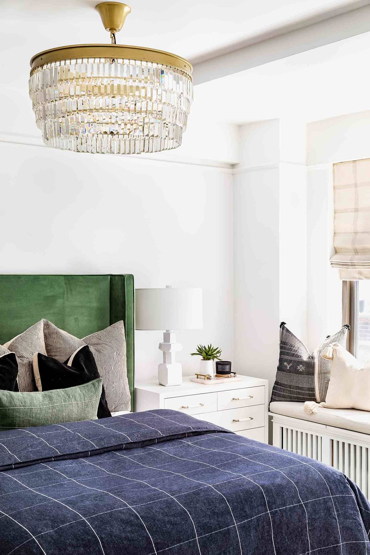 Small-and-space-savvy-bedroom-of-NYC-apartment-with-green-headboard-and-window-seat-55744