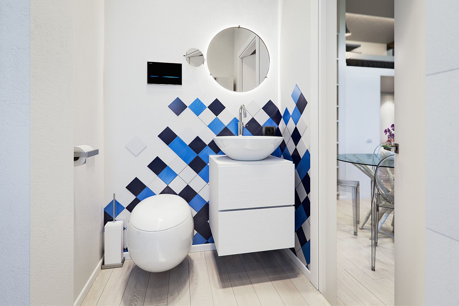 Small bathroom in white with pops of blue and dark gray