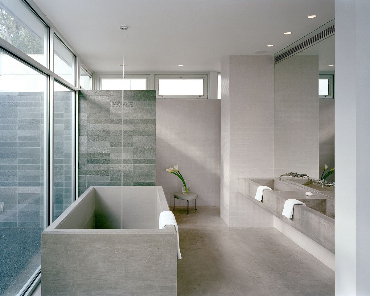 Spacious modern bathrom of New York home in gray with blu tiled shower area