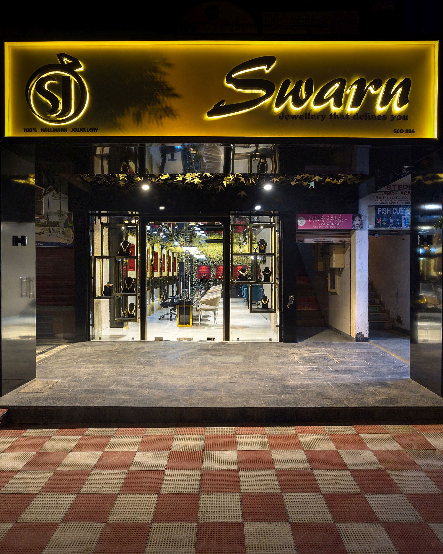 Street facade of modern jewelry store Swarn in Panchkula, India draped in black and gold