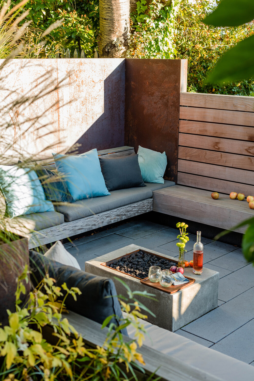 Sunken patio and fireplace create a lovely outdoor hangout that can be used to host guests and friends