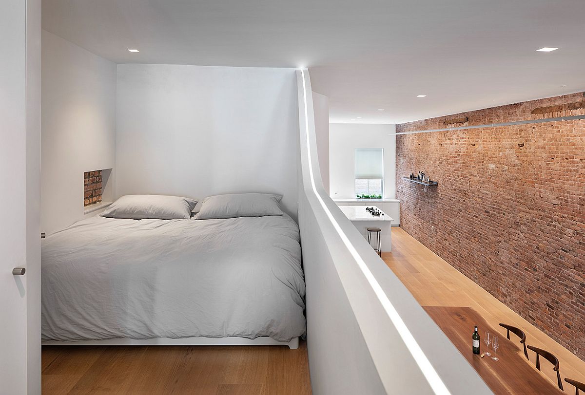 Tiny loft level bedroom inside NYC home with LED strip lighting that gives it a cool visual appeal