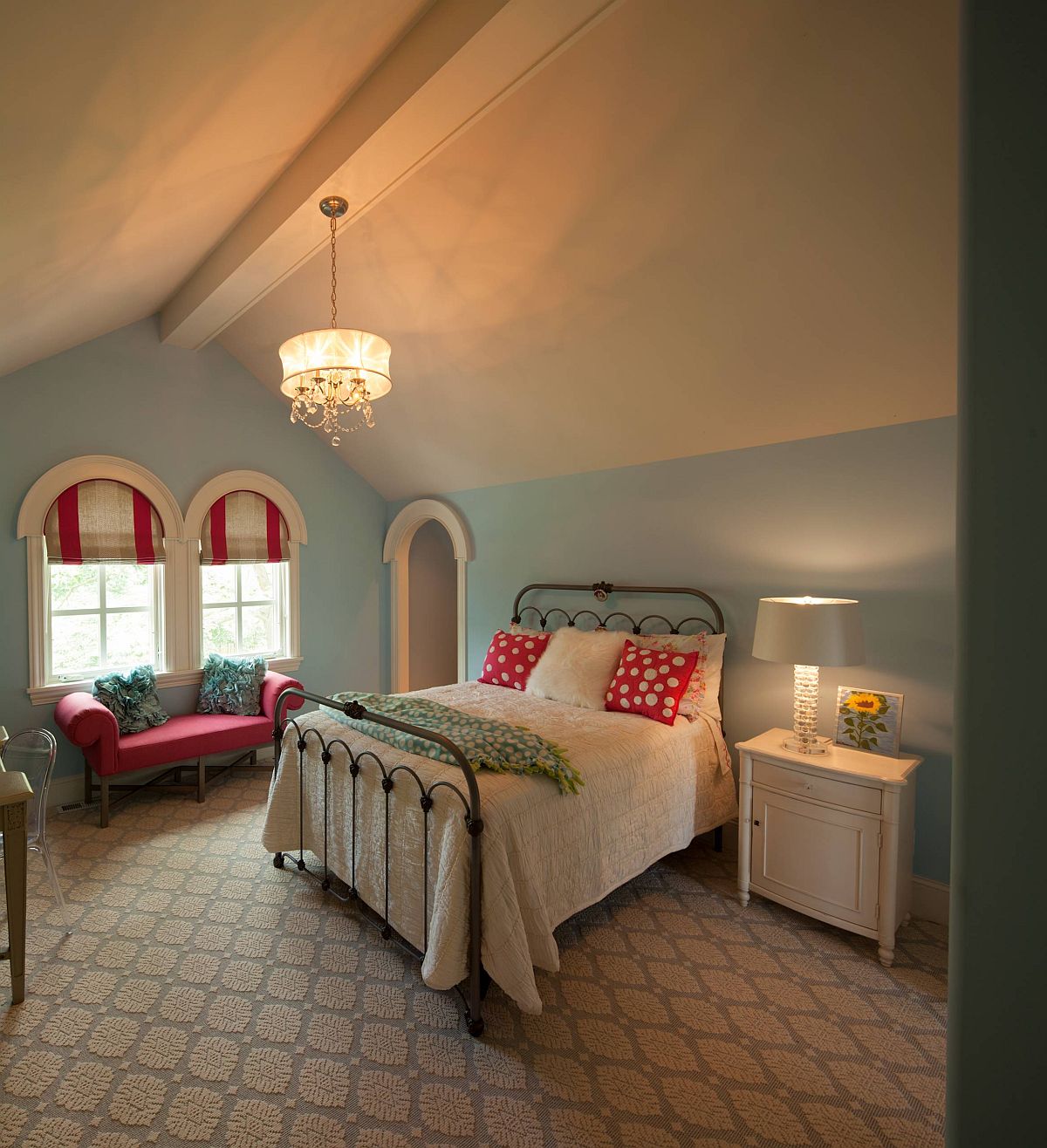 Traditional attic bedroom wih arched windows feels cozy and classic