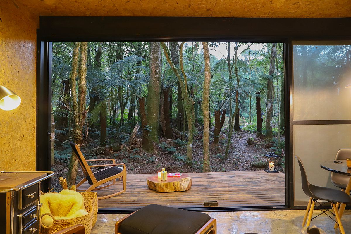 Translucent sliding glass panels connect the interior with the deck and view outside