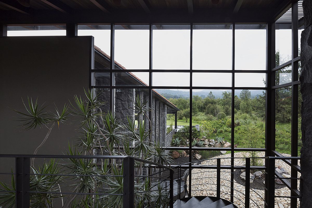 View of the water feature and garden outside the house from top of the stairway