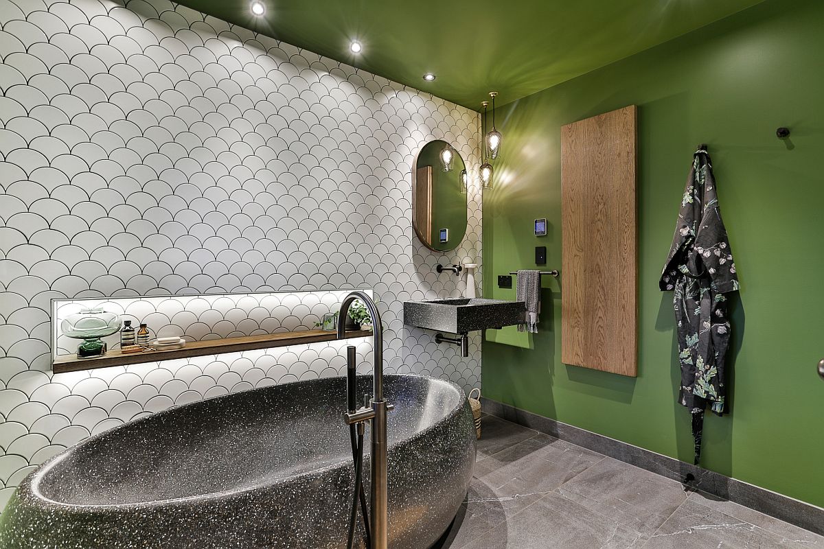 White tiles with fish scale design combined with bright green walls in the innovative bathroom