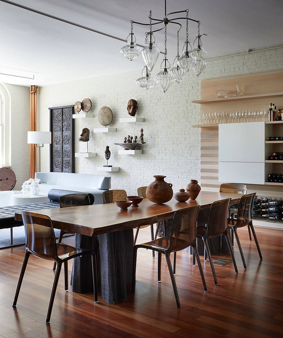 Whitewashed brick wall backdrop in the living area becomes a part of the dining space