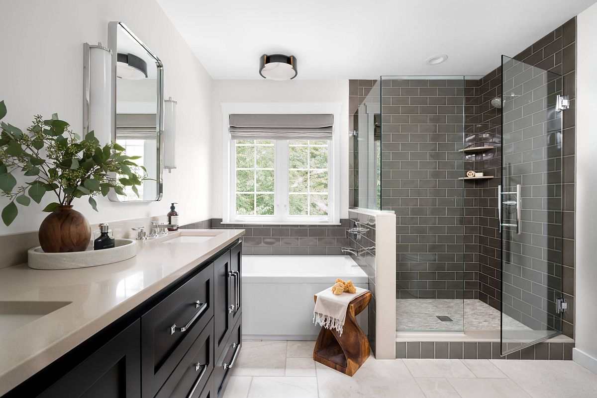 Wooden accent stool is an easy way to add woodsy element to the contemporary black and white bathroom