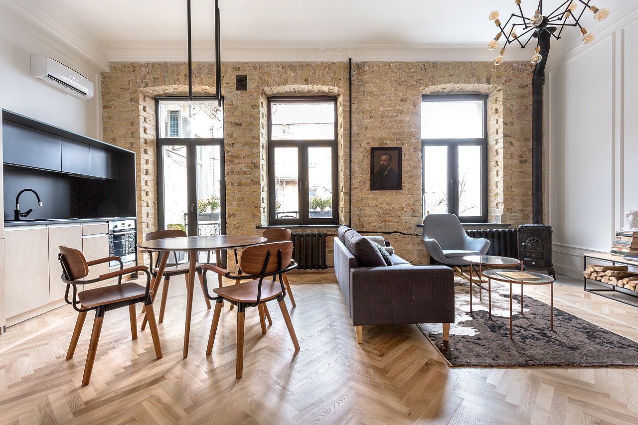 Beautiful and large windows bring ample natural light into the living area of the revamped apartment