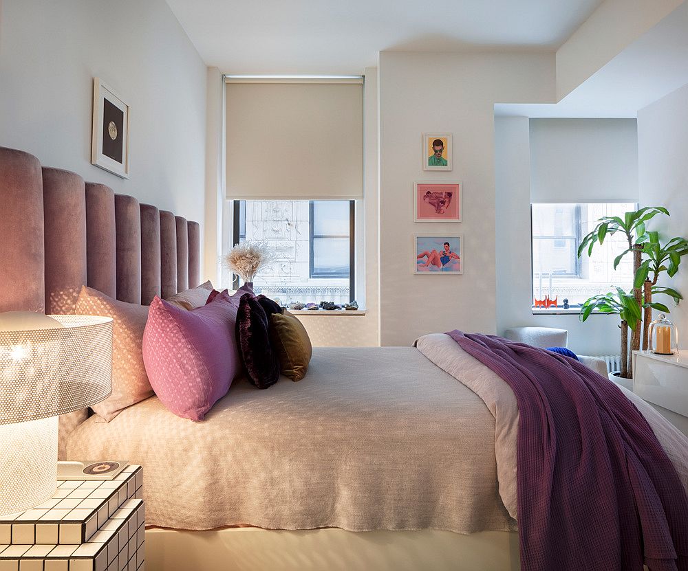 Bedding headboard and wall art pieces bring both color and contrast to the small bedroom in white