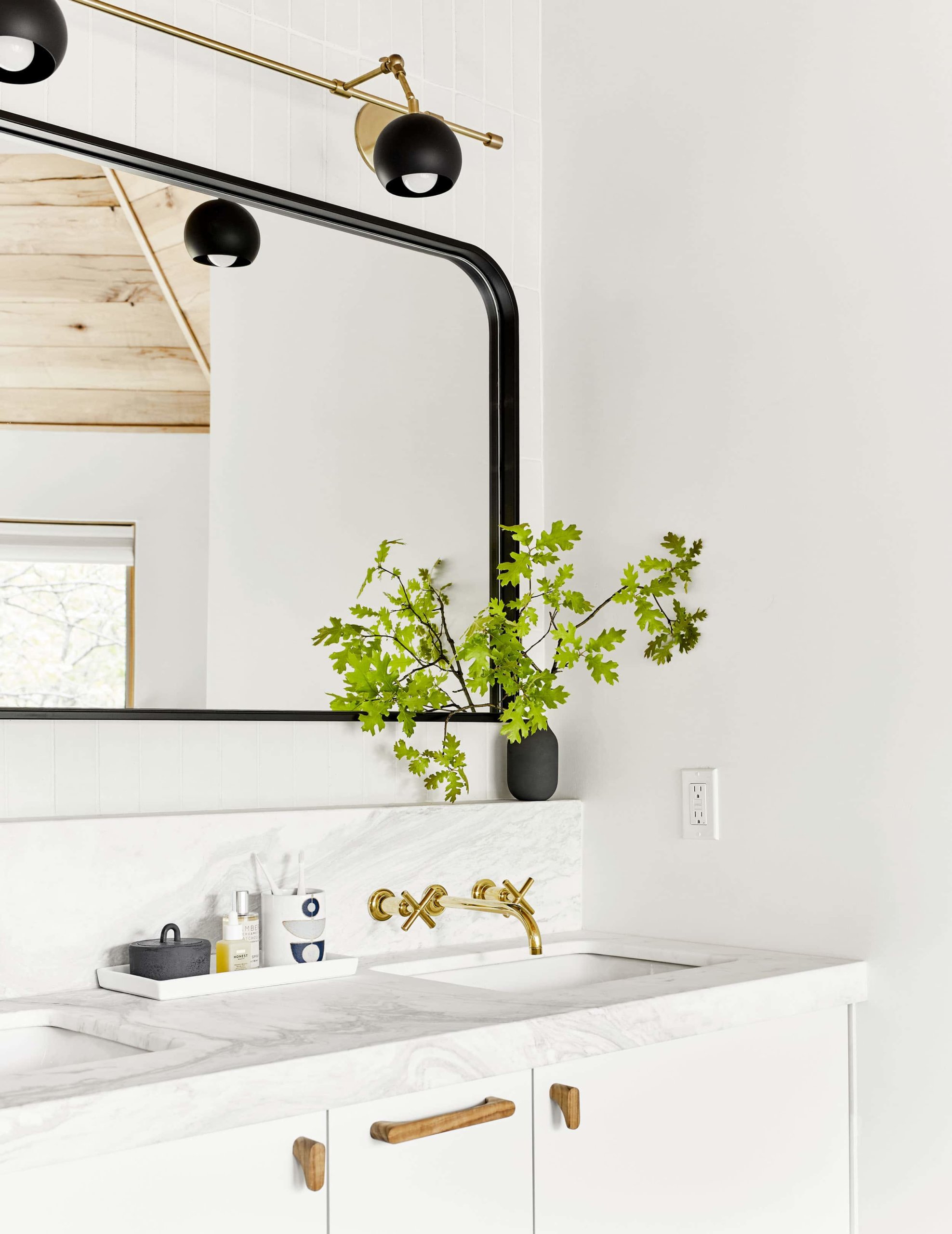 Black mirror in a refreshing white bathroom by Emily Henderson