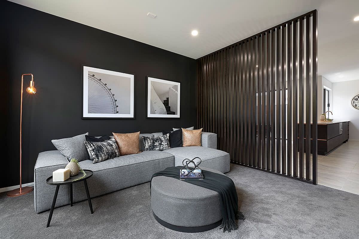 Black wall makes for a lovely backdrop in the spacious, modern living room with gray floor and decor