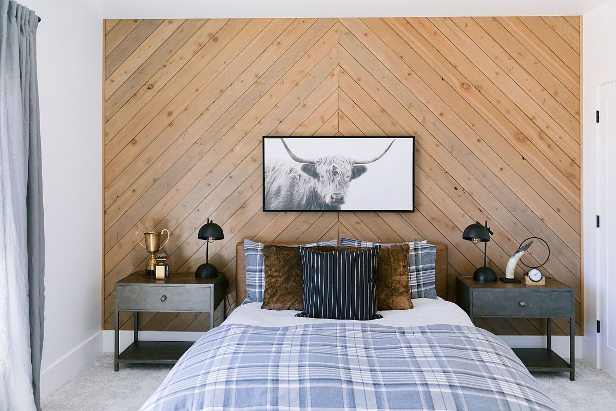 Chevron pattern accent wall for the rustic bedroom in wood along with bedding that adds ample pattern to the bedroom