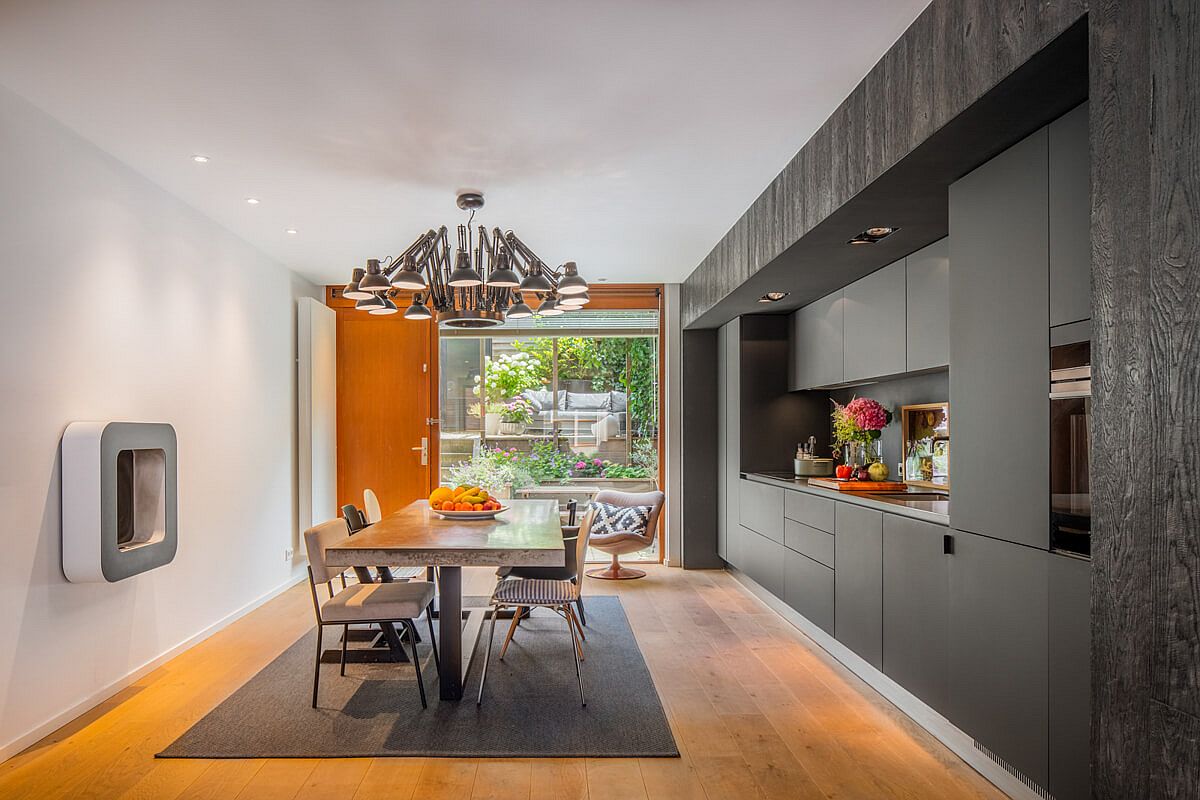 Creating a kitchen and dining area with white walls, gray cabinet and wooden floor that adds visual warmth