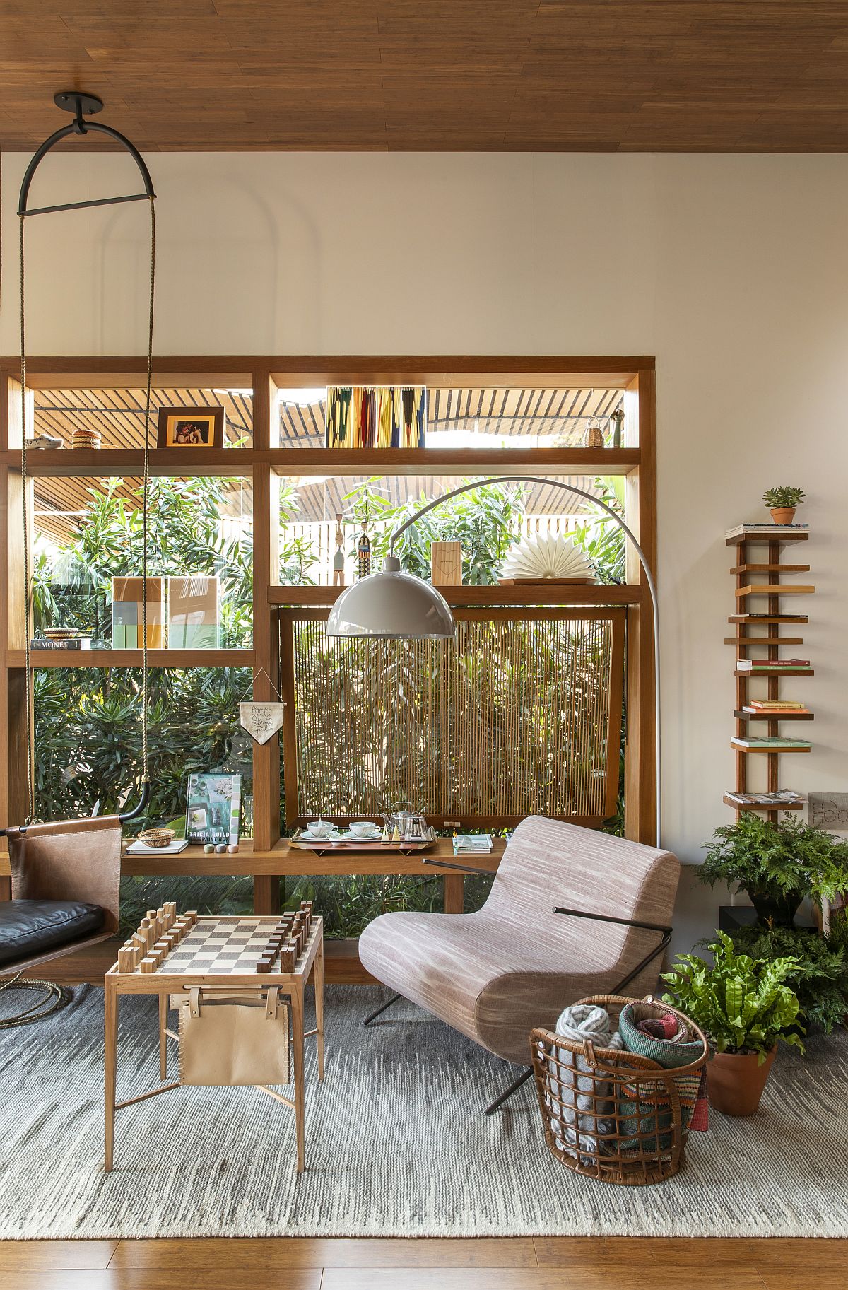 Custom wooden shelf and glass walls give the family room a bespoke look