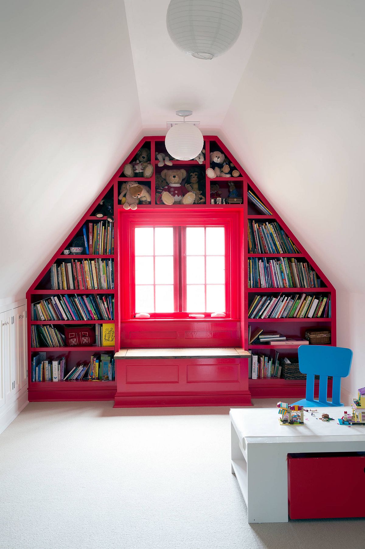 Custom bookshelf and storage area for all your kids' needs inside the lovely contemporary attic playroom